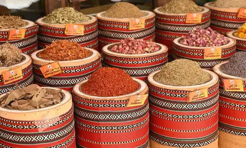 Aromatic spices and herbs in woven baskets at a local spice souk.