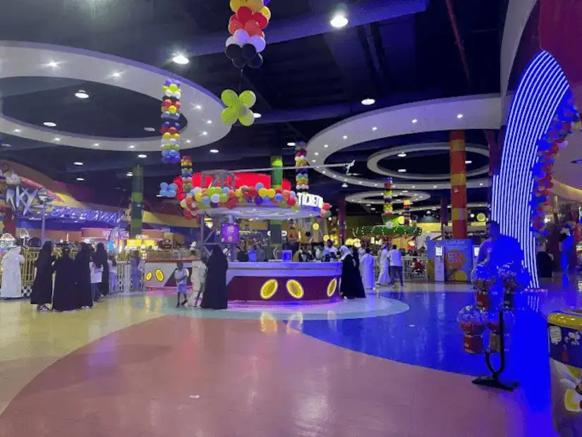 people and kids in the kids' playground in the mall