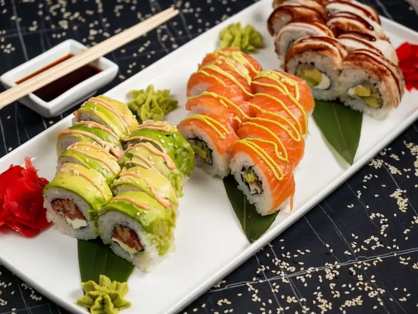 A variety of sushi rolls with vibrant garnishes.