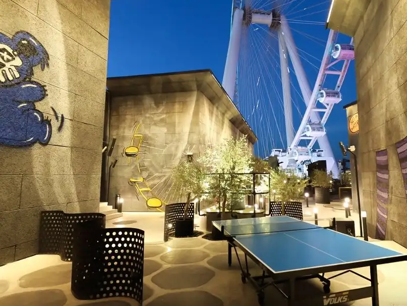 Trendy rooftop terrace with a ping pong table and cityscape views.