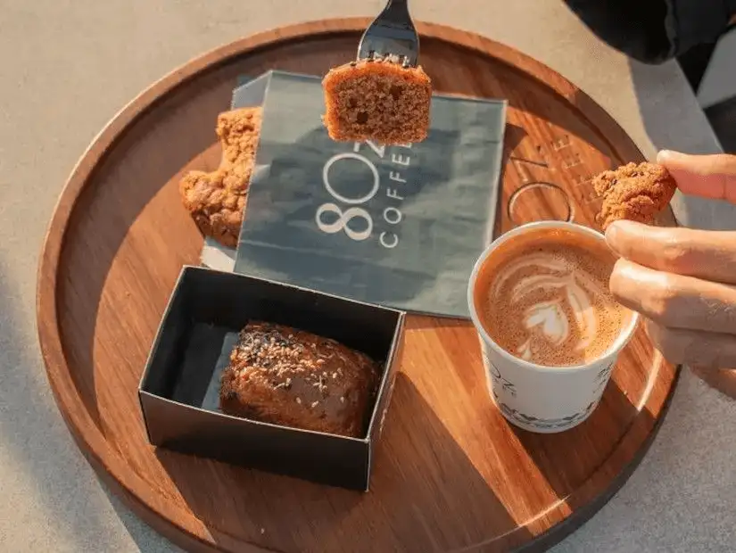 Fresh coffee paired with a savory muffin at 8OZ Coffee Shop.