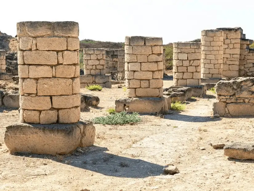 Ancient stone columns standing at the Al Baleed Archaeological Site.