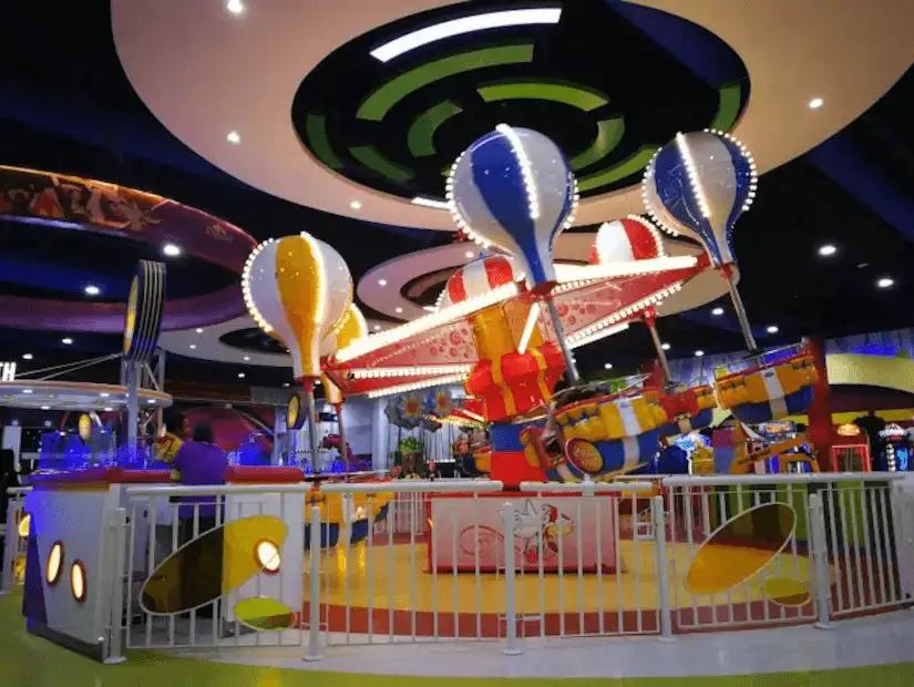 A lively amusement area at Al Hokair Time, with colorful rides and attractions for children.