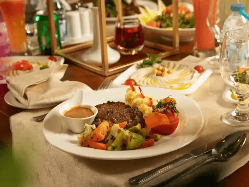 Elegant dining setting with a succulent steak meal and refreshing beverages.