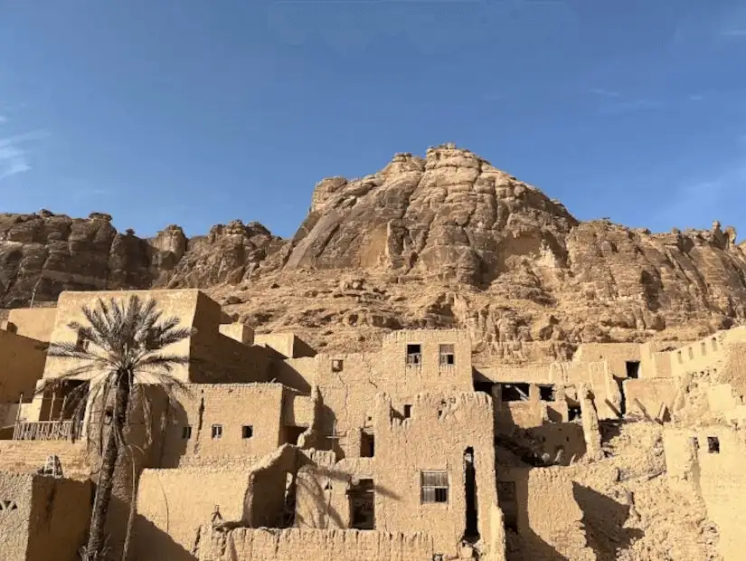 The remnants of AlUla’s golden sandstone buildings nestled against the cliffs.