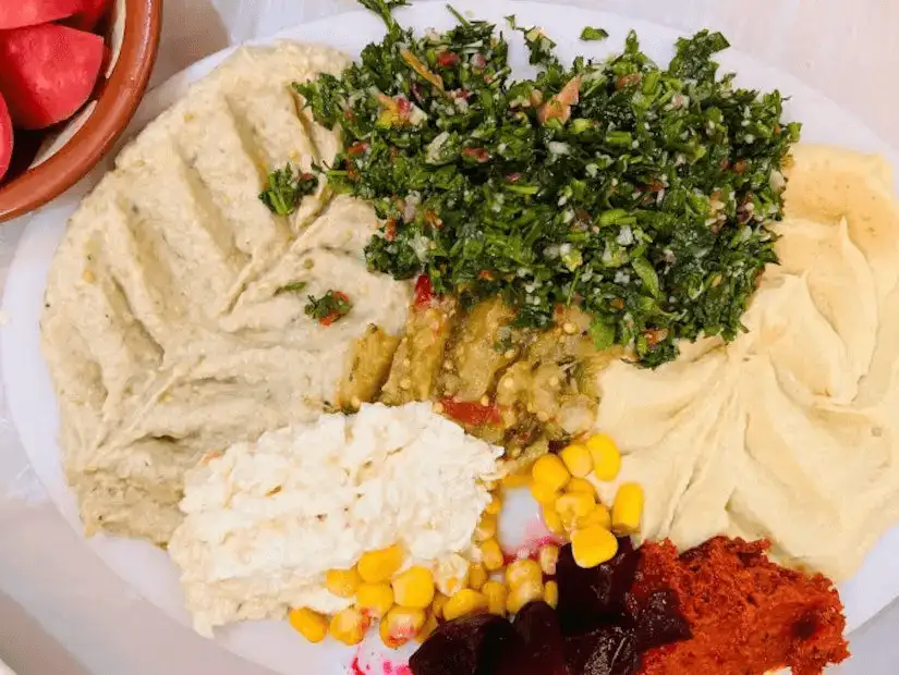 A vibrant selection of Middle Eastern dips and salads, including hummus and tabbouleh.