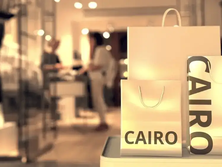 Close-up of a luxury shopping bag in a boutique setting with 'CAIRO' branding, representing upscale urban shopping.