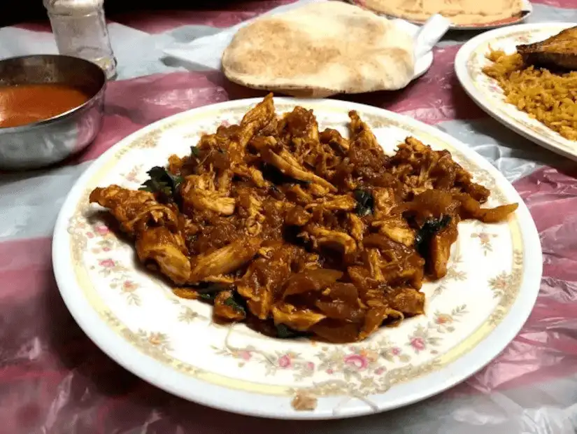 A traditional Omani chicken dish, rich in spices and flavor at Bin Ateeq Restaurant.