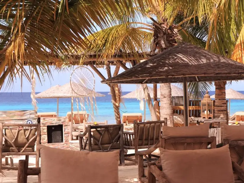 Rustic and cozy seating area at Chiringuito, overlooking the beautiful blue sea.