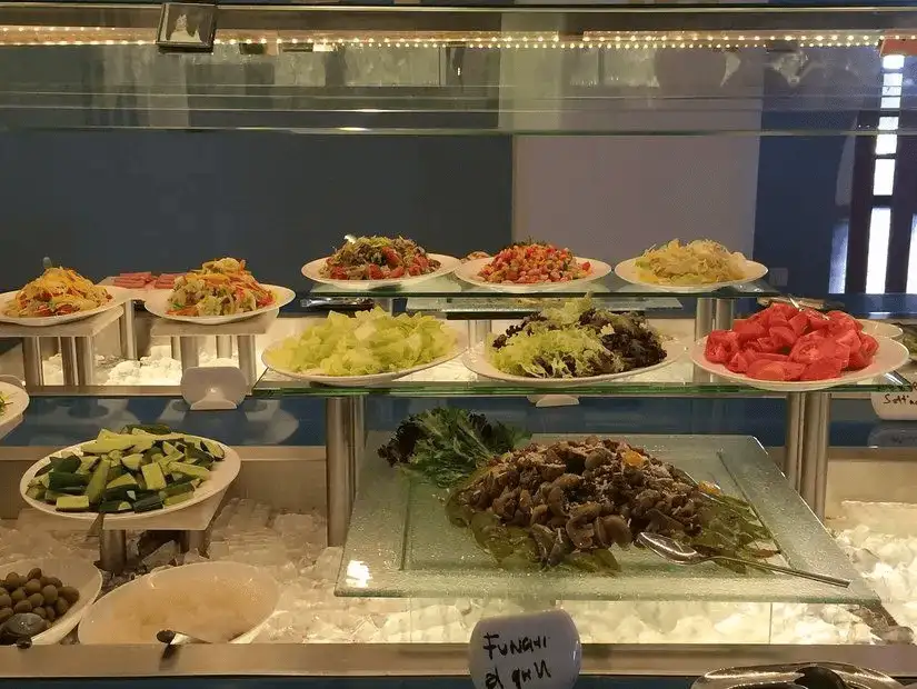 A colorful assortment of fresh salads and greens on display at Darbat Restaurant.