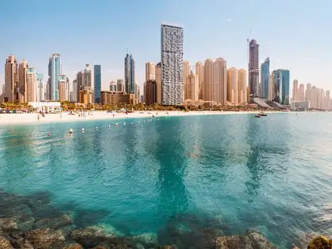 A panoramic view of Dubai's skyline and beach, where the tranquility of the sea meets the hustle of the city.