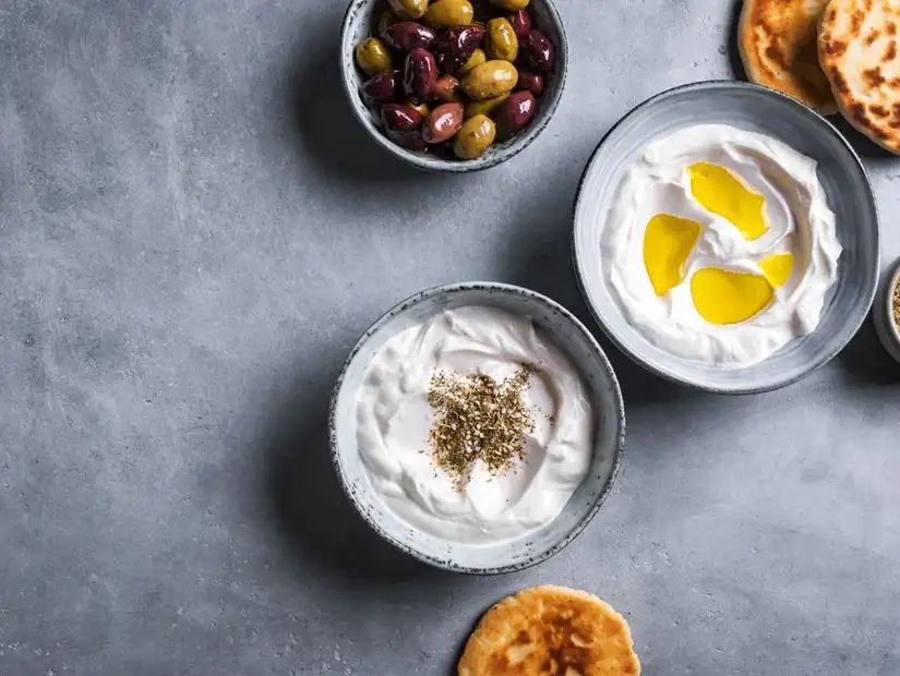 Crispy falafel balls served with a creamy avocado dip, garnished with fresh flowers.