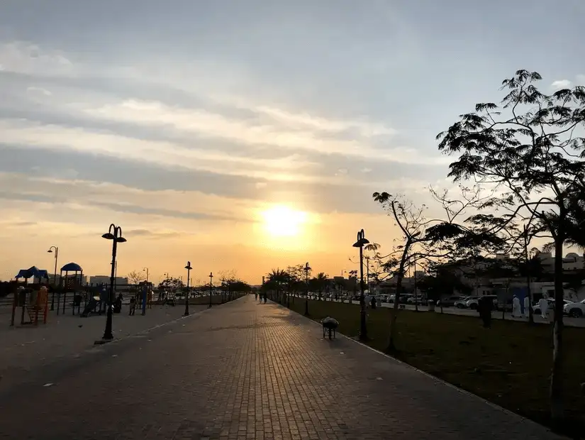 A tranquil sunset paints the sky above a bustling promenade at Fayhaa Park, inviting an evening stroll.