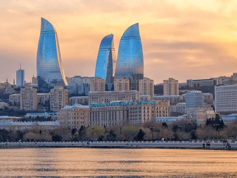 The iconic Flame Towers illuminated against the evening sky.