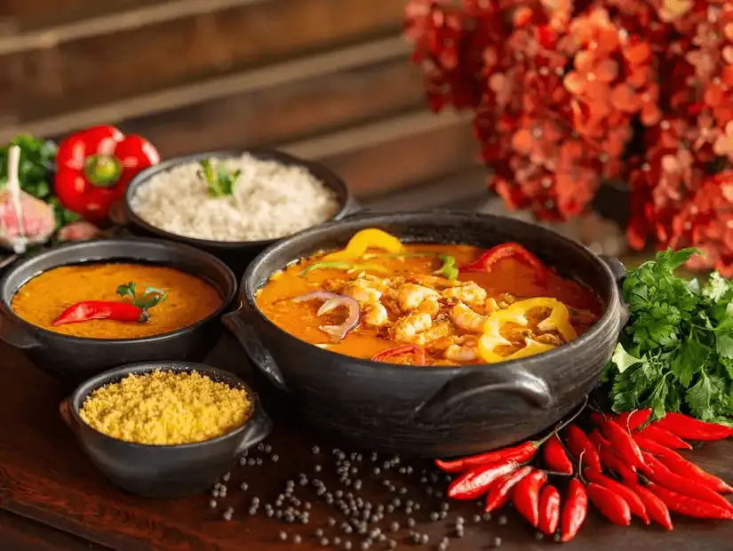 Sizzling Brazilian barbeque with an assortment of meats and savory sauces in clay pots.