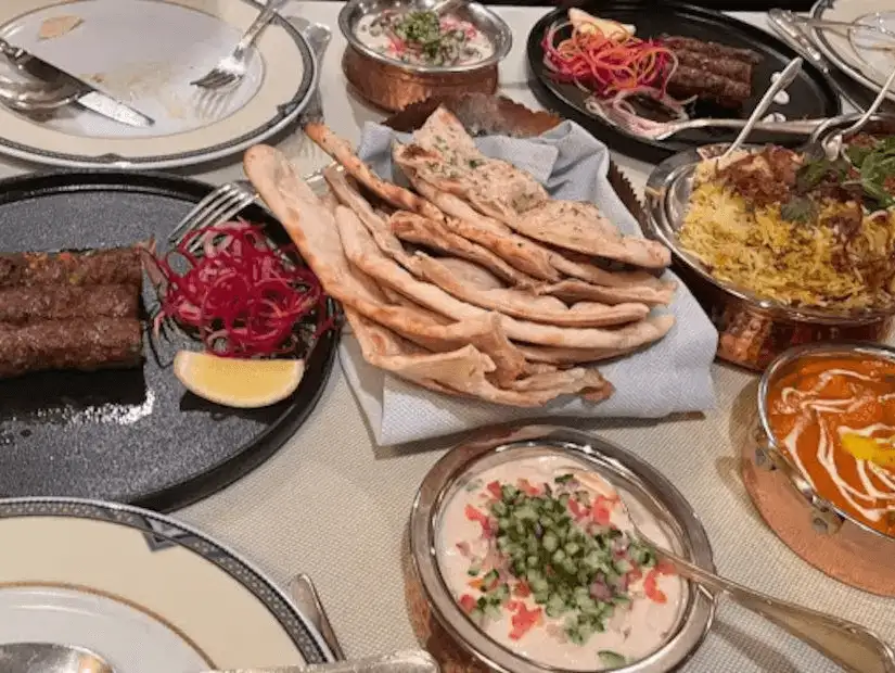 An array of Persian cuisine, with kebabs, bread, and richly flavored sides.