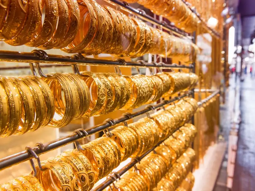 Rows of golden bangles gleam under the lights, each carved with exquisite detail.