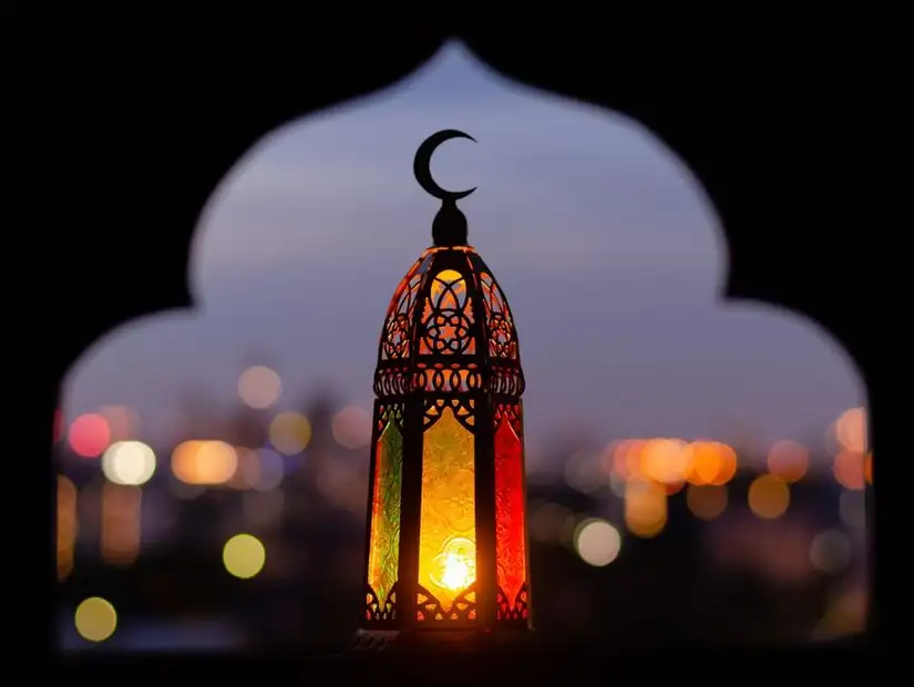 An ornate lantern against the evening city lights.