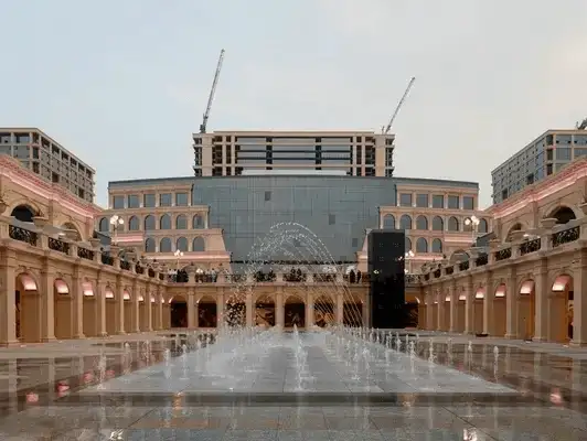 An expansive courtyard with a fountain set against a backdrop of classical architecture.