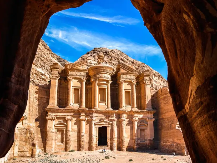The ancient facade of Al-Khazneh in Petra framed by rocky cliffs