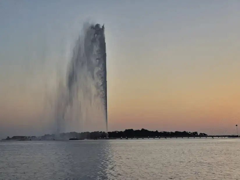 The King Fahad fountain against a peaceful twilight sky.