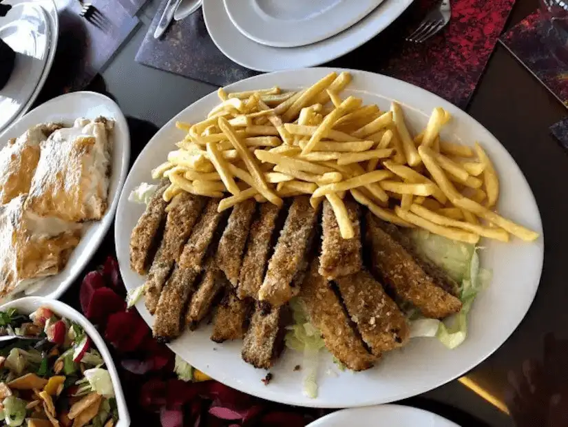 Fried fish fillets served with golden fries and a side salad for a casual meal.