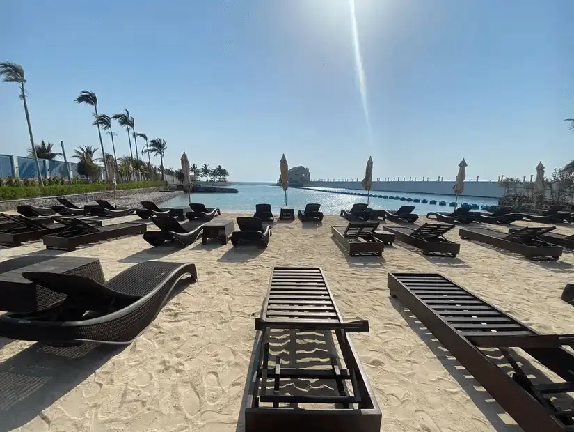 Inviting beachside loungers ready for sunbathers by the tranquil sea.
