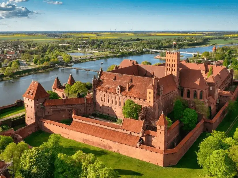 The magnificent Malbork Castle, one of the largest medieval castles in Europe, standing tall along the Nogat River.