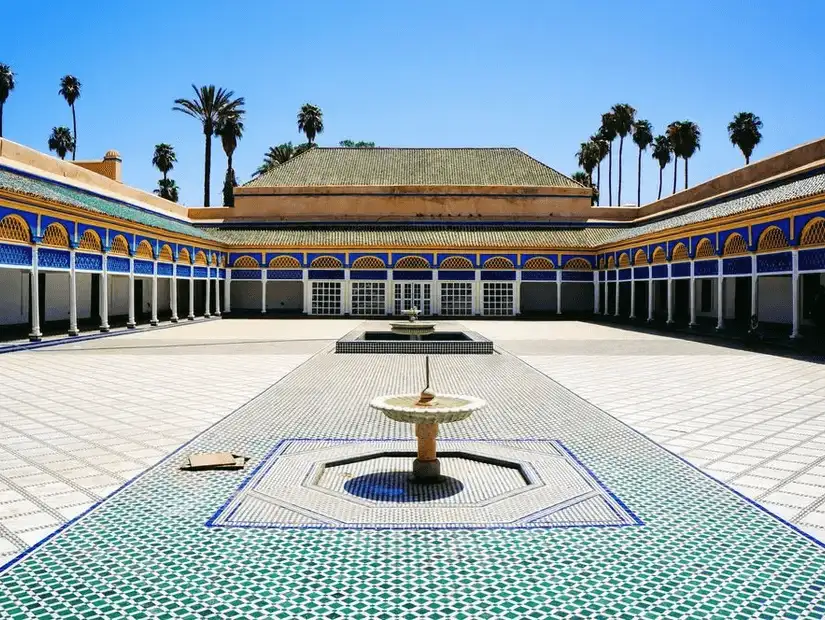 A serene courtyard with a fountain in a Marrakesh palace.