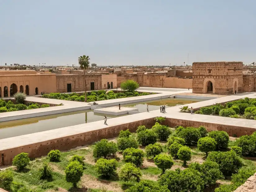 Ancient palace ruins amidst lush gardens in Marrakesh.