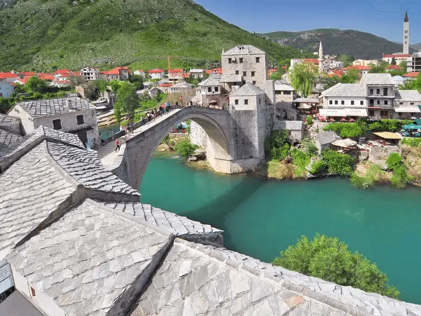 The ancient bridge of Mostar spans the emerald waters of the Neretva River.