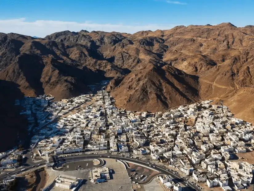 A stunning aerial view of Mount Uhud, with the city nestled at the base of the rocky hills.