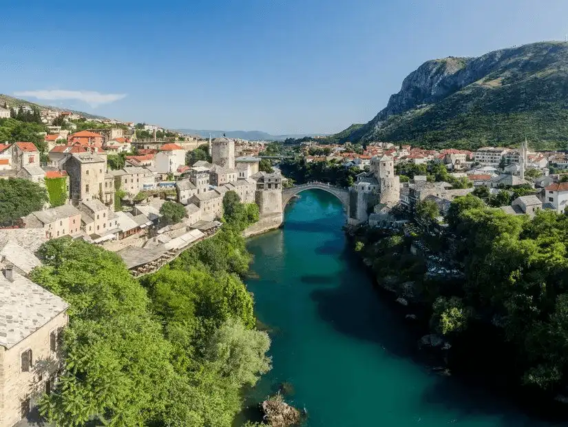 The serene Neretva River flowing through a picturesque Bosnian landscape.