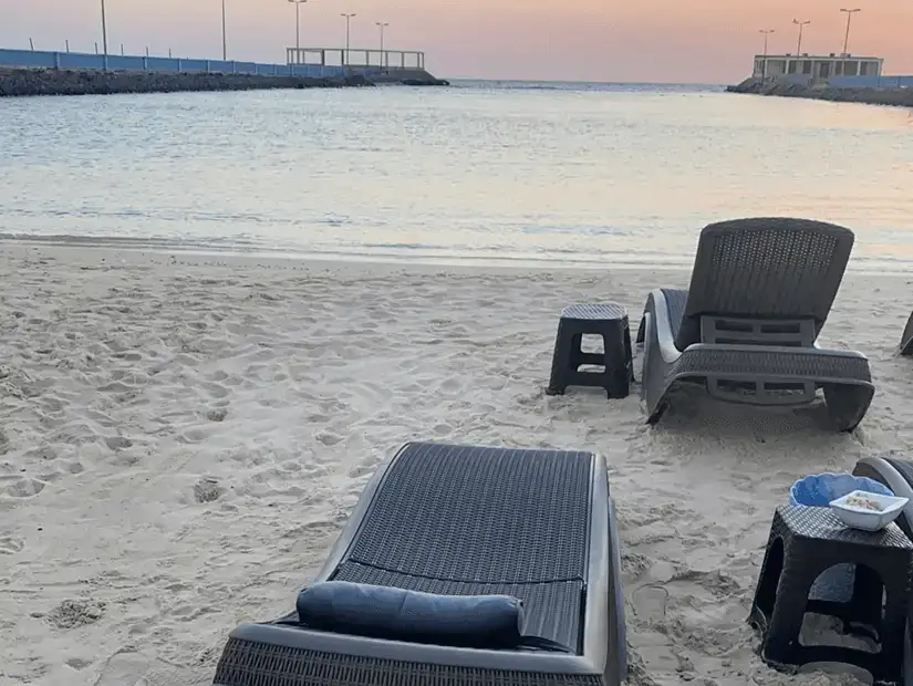 Twilight serenity with beach chairs facing the calm waters, offering a perfect spot for evening relaxation.