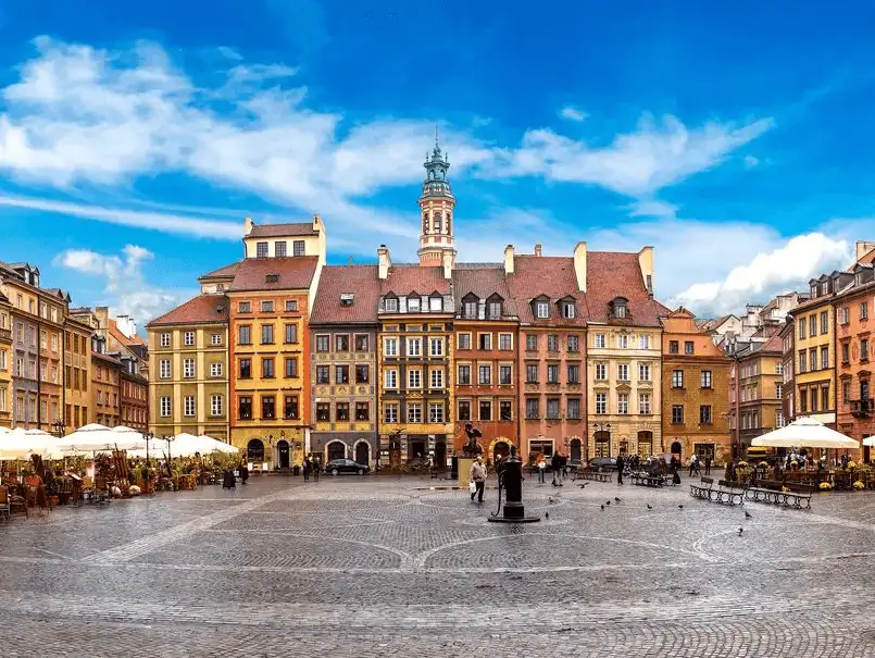 A panoramic view of Warsaw's Old Town Square, a colorful blend of historic buildings and lively atmosphere.