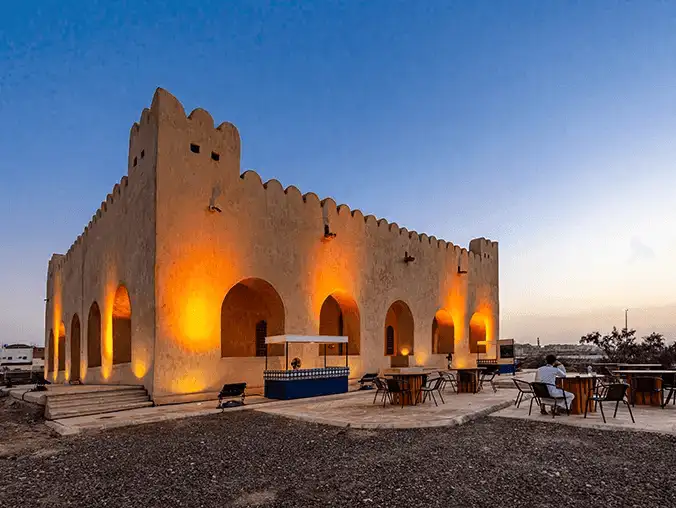 The Palace of Urwa bin Al-Zubayr, illuminated at dusk, showcasing its majestic architecture.