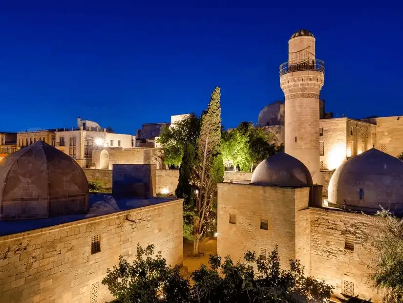 The historic Palace of the Shirvanshahs illuminated at night.