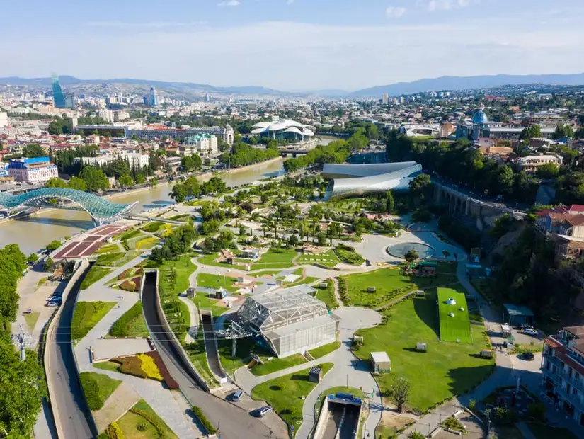The panoramic view of Rike Park, Peace bridge, and the Kura river in Tbilisi, Georgia.
