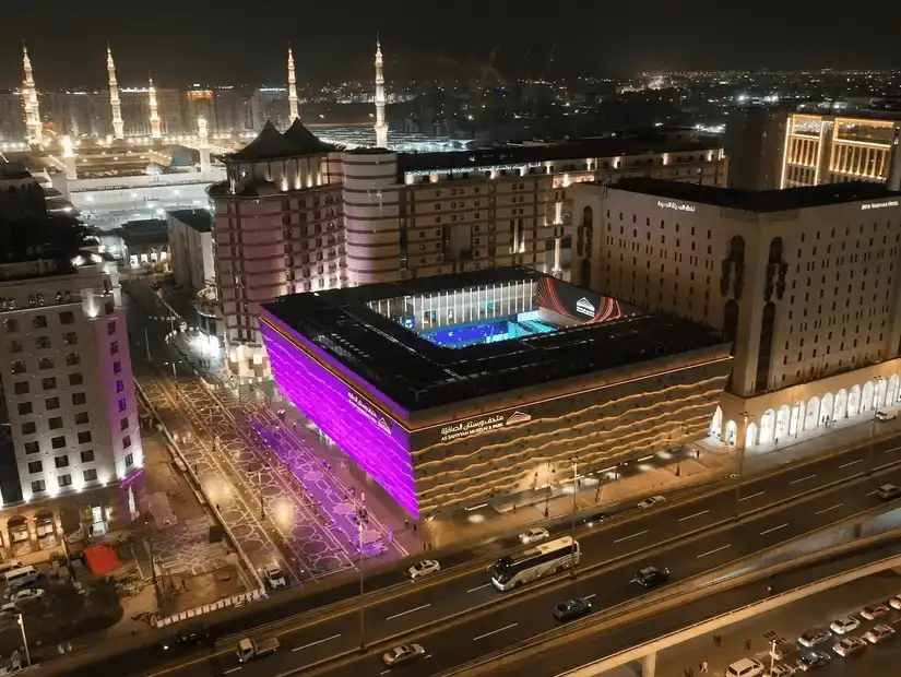 A nighttime view of Safia Museum, with vibrant lights illuminating the surrounding area.