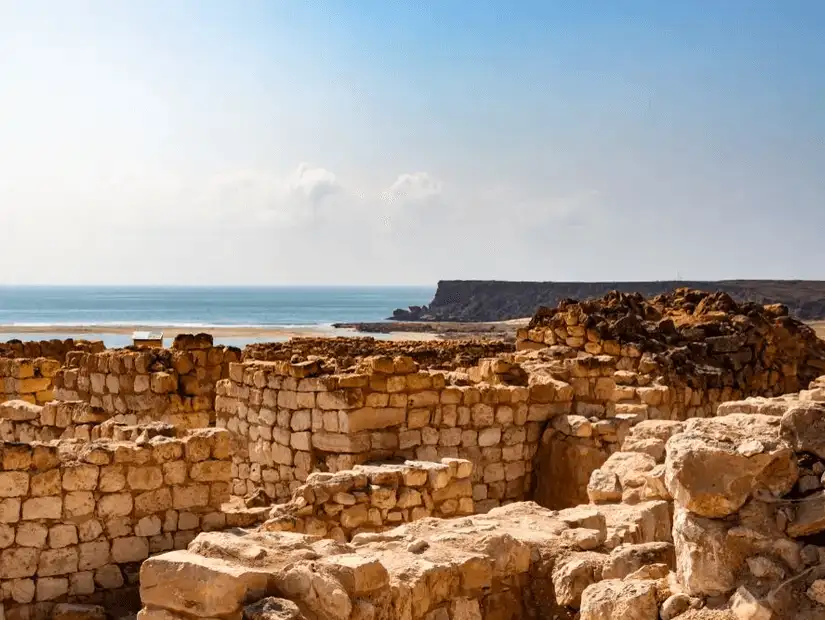 Ruins of the ancient Samahram Old City overlooking a calm sea.