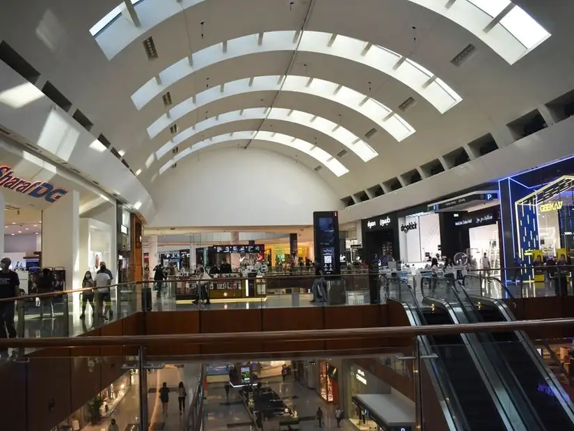Sleek architecture meets shopping convenience under a modern curved ceiling.