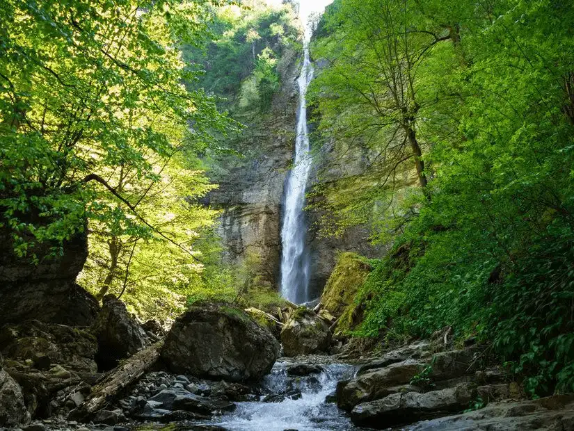 The Skakavac Waterfalls cascade amidst lush greenery.