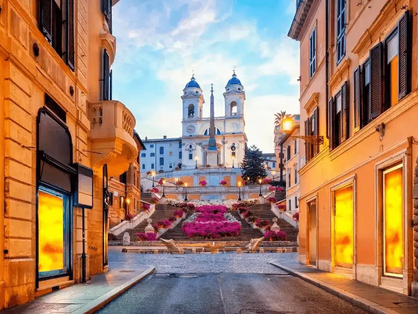 The charming Spanish Steps adorned with vibrant flowers, leading up to Trinità dei Monti.