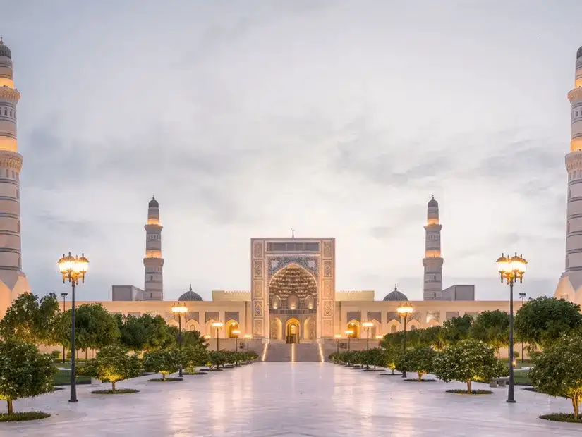 The majestic Sultan Qaboos Mosque in Salalah illuminated at twilight.