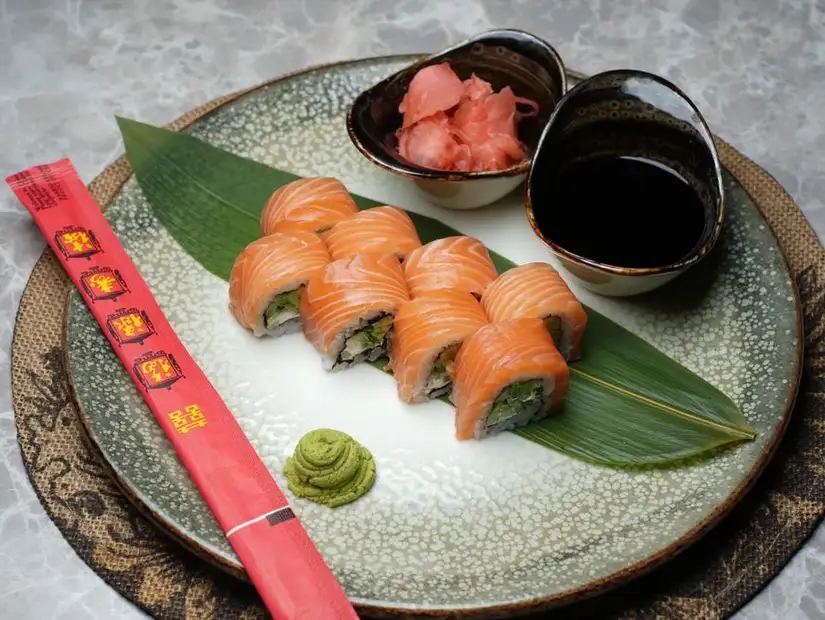 Fresh salmon sushi rolls with wasabi and soy sauce.