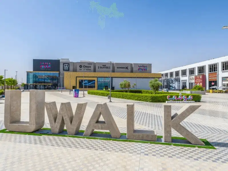 The iconic 'U WALK' sign at a trendy outdoor commercial complex, inviting visitors to a blend of leisure and retail.