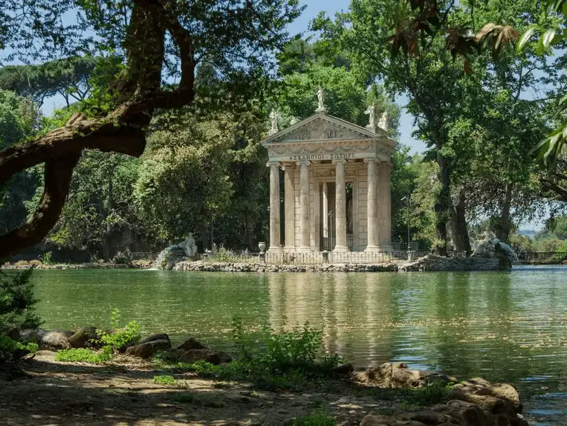 The tranquil Temple of Aesculapius nestled beside a serene lake in Villa Borghese.