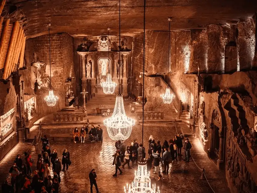 A breathtaking underground chapel in the Wieliczka Salt Mine, adorned with crystal chandeliers and salt-carved sculptures.