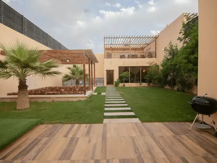 Elegant chalet with a pool and lush green surroundings.