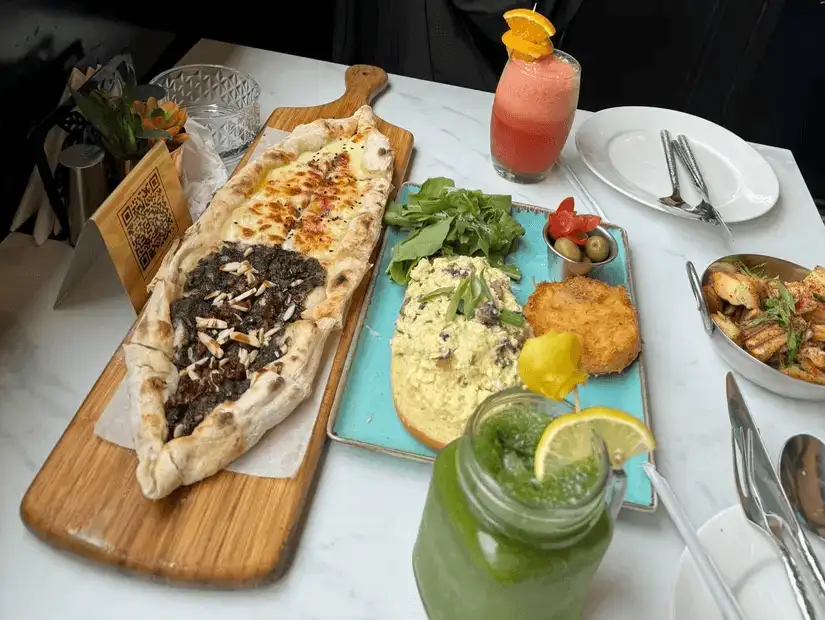 Falafel and traditional breakfast items, including pickled vegetables and creamy labneh.